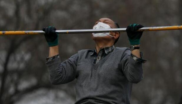 北京持续雾霾 市民戴口罩公园晨练