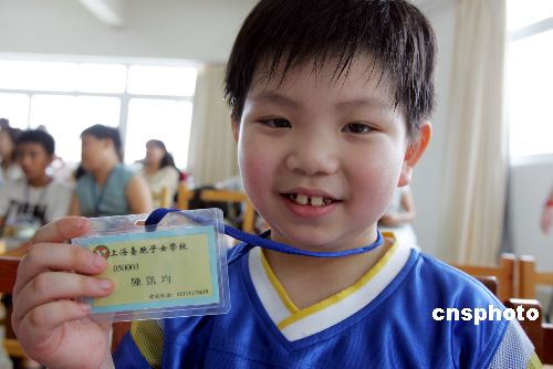 图为台湾小朋友陈凯领到学生证后露出喜悦的笑
