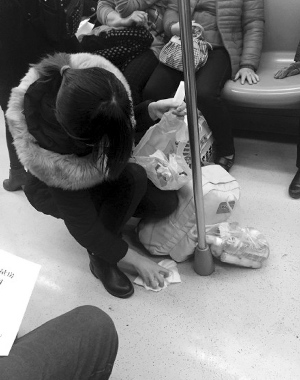 儿子地铁内呕吐妈妈蹲下把地擦得干干净净（图）
