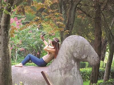 资料图:今年9月,媒体曝出有女子爬上石兽玩自拍,姿势不停变换。图片来源:扬子晚报 资料图:今年9月,媒体曝出有女子爬上石兽玩自拍,姿势不停变换。图片来源:扬子晚报