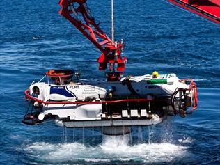 A submersible clears the water after a successful personnel transfer