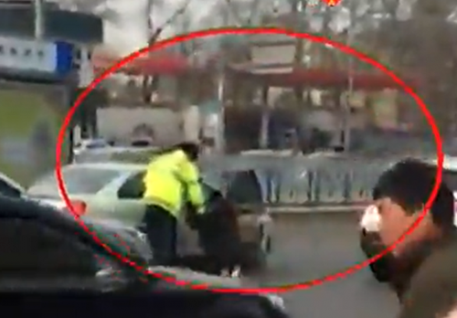 ����ͣ����·�м䣬Ů�Ӿ����Աߴ��֣�һ���谭�˽�ͨ��������ֻ�ܱ�Ȱ���ά���ֳ���ͨ����