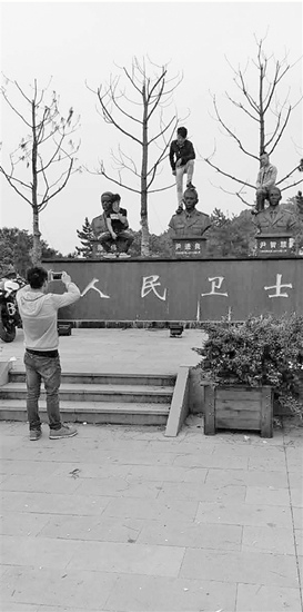 游客脚踩消防烈士铜像拍照犯众怒警方已介入调查